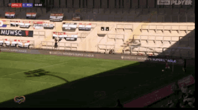 a soccer stadium with a muwsc banner on the side
