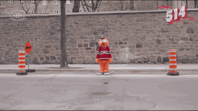 a mascot wearing a canadiens jersey stands on the sidewalk
