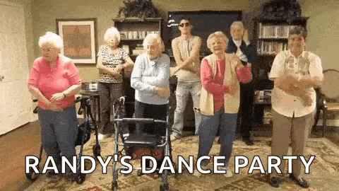 a group of older people are dancing in a living room .