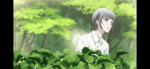 a girl in a white shirt is peeking out from behind a bush