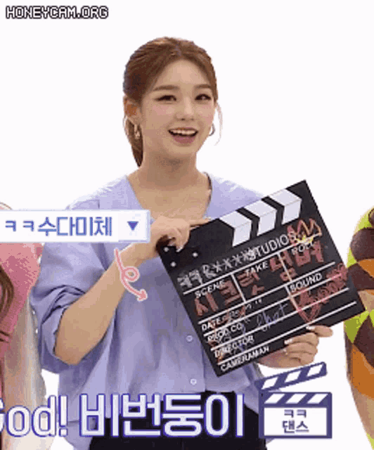 a woman is holding a clapper board that says ' take work ' on it