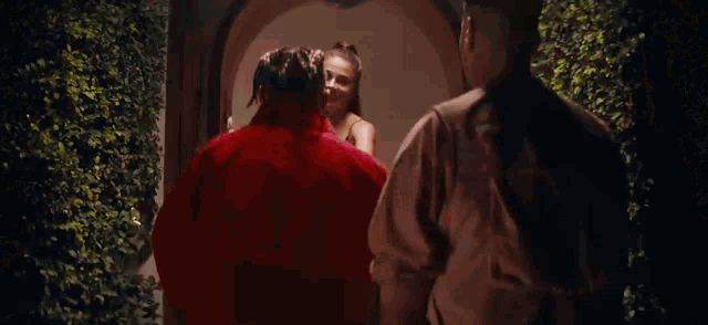a man and a woman are standing next to each other and talking .