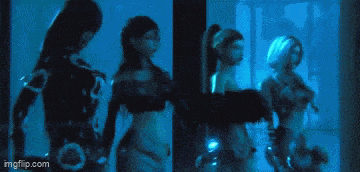a woman with blue hair is standing in a dark room behind bars .