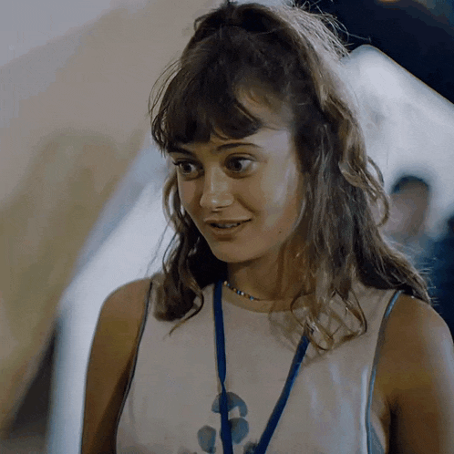 a woman with a lanyard around her neck that says ' 3 ' on it