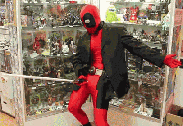 a man in a deadpool costume holds a sword