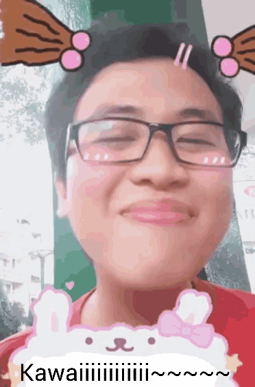a man wearing glasses and a red shirt has a sticker on his face that says kawaii on it