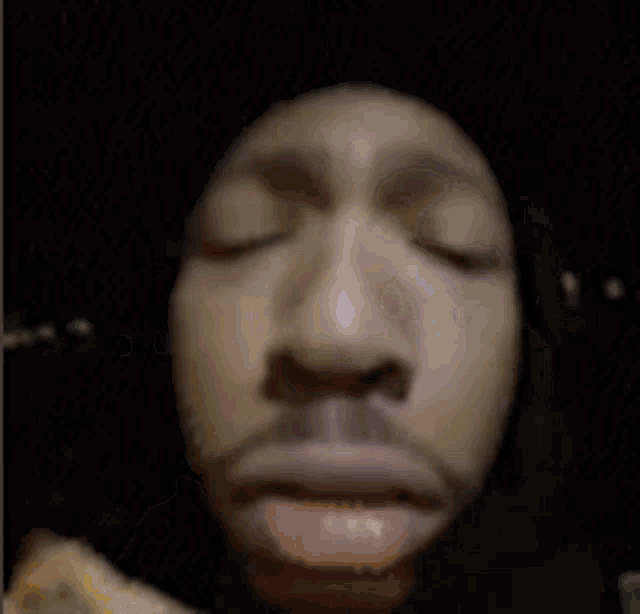 a close up of a person 's face eating a piece of food