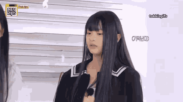 a girl with long black hair is standing in front of a sign that says new trends