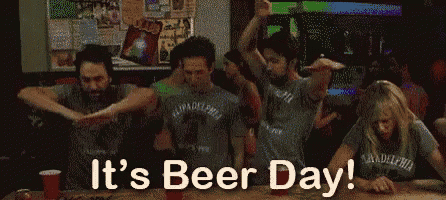 a group of people are dancing in a bar and the words it 's beer day are above them