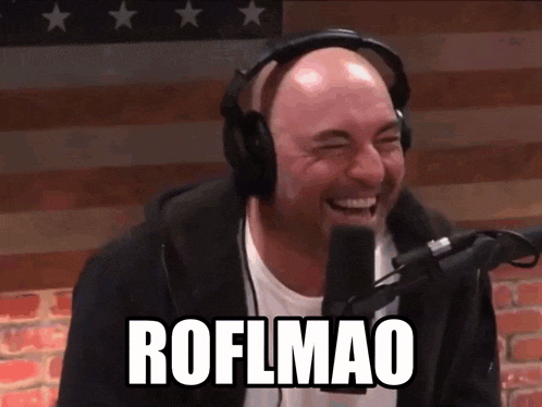 a man wearing headphones is laughing in front of a microphone and the words roflmao are visible