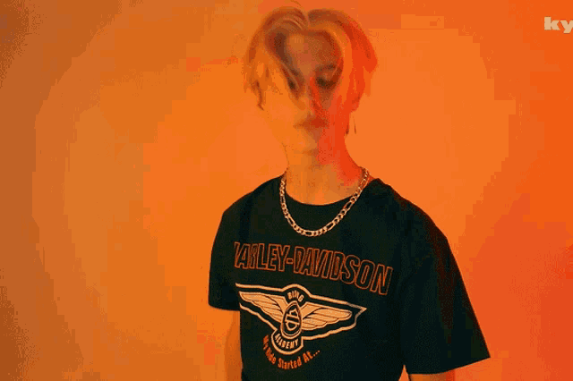 a person wearing a harley davidson t-shirt with a chain around their neck