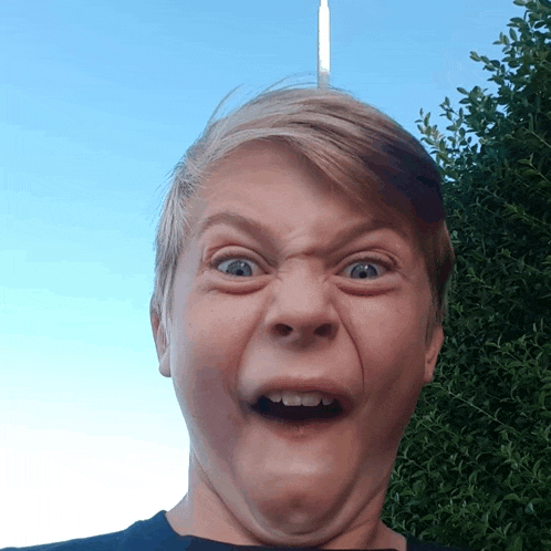 a young boy making a funny face with his mouth wide open