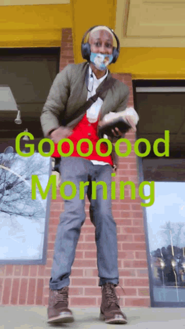 a man wearing headphones and a mask says good morning in green
