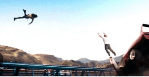 a man is doing a flip over a car in the air