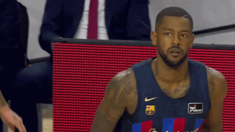 a basketball player wearing a jersey that says ' liga endesa ' on the front