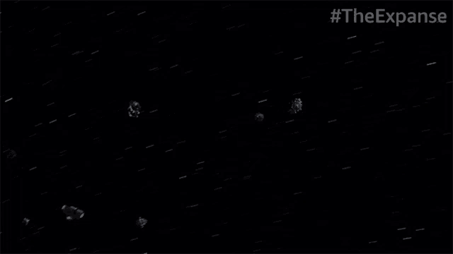 a group of asteroids are flying through space in a black background .