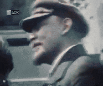 a man in a military uniform is saluting in front of a 24 aok logo