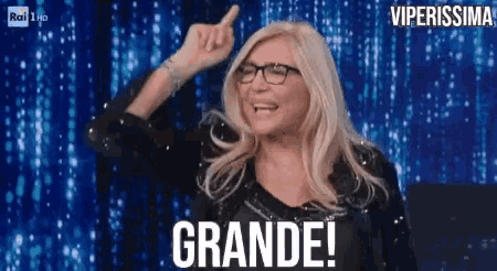 a woman wearing glasses and a black jacket with the words grande written on it