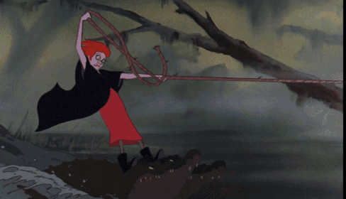 a girl in a red dress is holding a rope