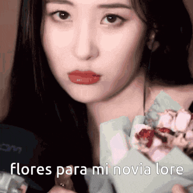a close up of a woman holding a bouquet of flowers with flores para mi novia lore written on the bottom