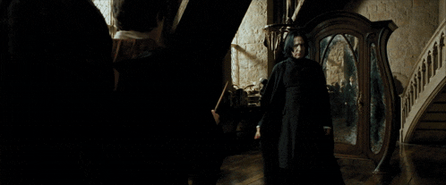 a woman in a witch costume stands in front of a mirror