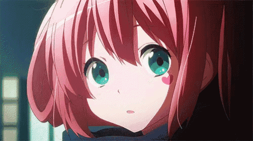 a close up of a anime girl with pink hair and green eyes .