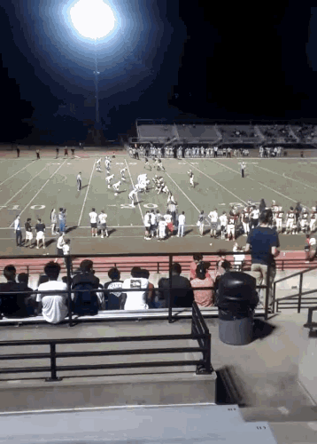 a football game is being played in a stadium