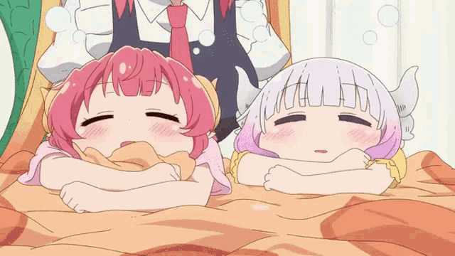 a couple of anime girls laying on a bed