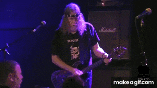 a man is playing a guitar in front of a marshall amp