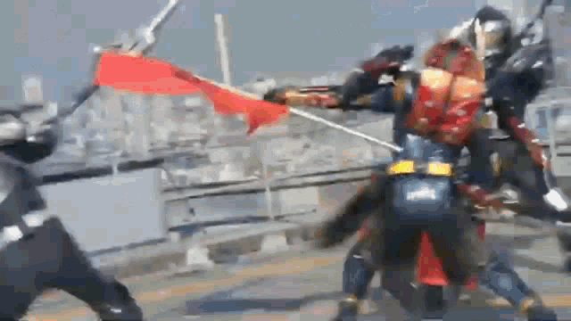 a group of samurai are fighting each other with swords and shields .