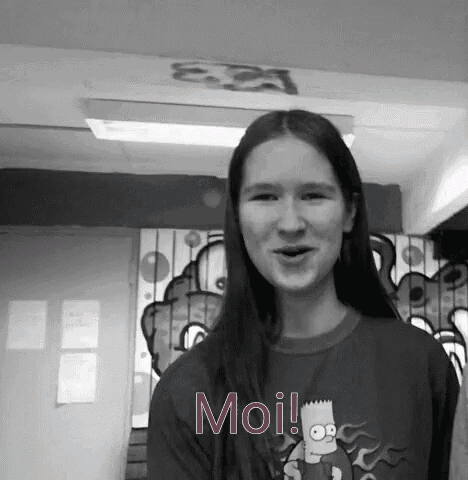 a woman wearing a bart simpson shirt is standing in front of a wall with graffiti on it and says moi