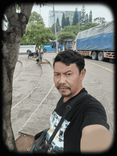 a man taking a selfie in front of a truck