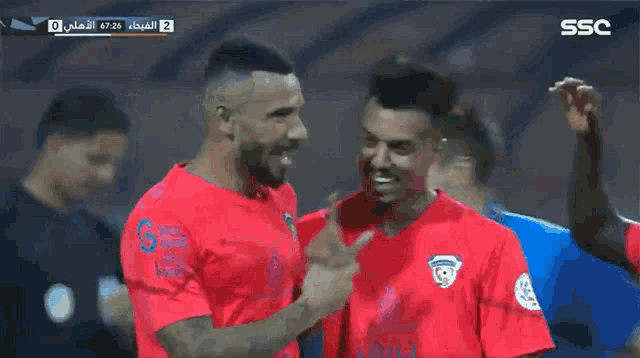 a soccer player in a red jersey with ssc on the bottom right