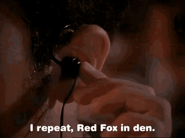 a man talking on a cell phone with the words i repeat red fox in den