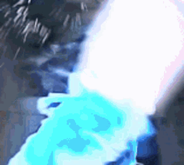 a close up of a person holding a light saber in a dark room .