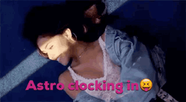 a woman laying on the ground with the words astro clocking in