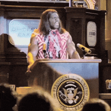 a man stands behind a podium with the presidential seal on it
