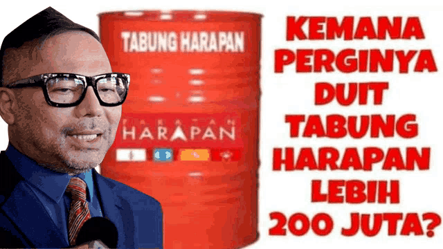 a man in a suit and tie is standing in front of a red barrel that says tabung harapan