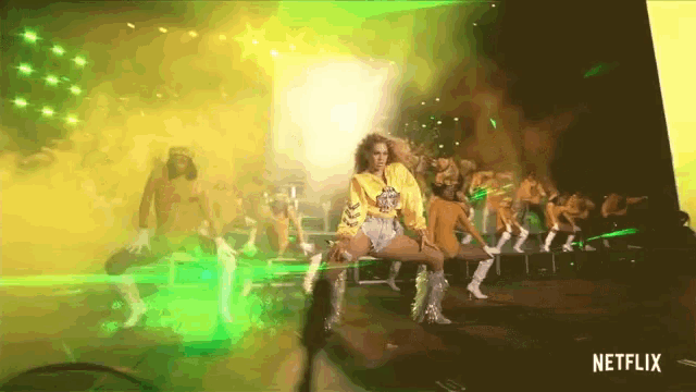 a netflix ad shows a woman in a yellow hoodie dancing on a stage