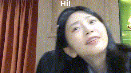 a woman with long black hair is looking up at the camera while wearing headphones and a headband .