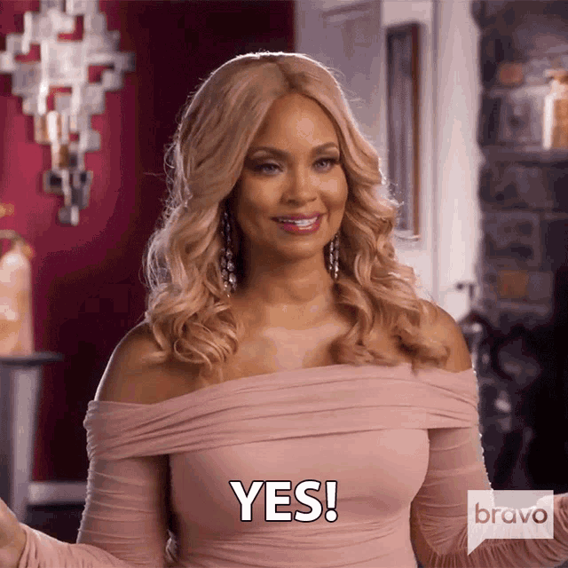 a woman in a pink off the shoulder dress is saying yes