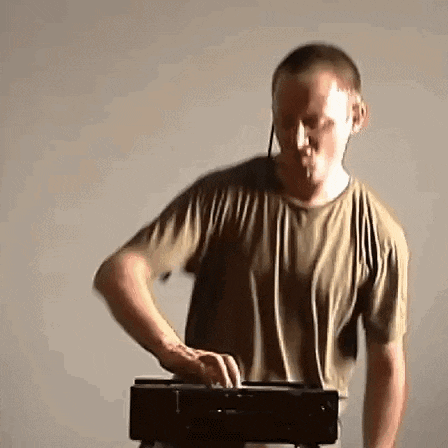 a man wearing headphones is playing a keyboard ..