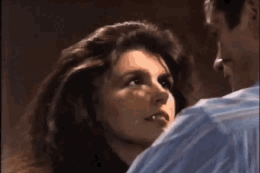 a man and a woman are looking at each other in a close up