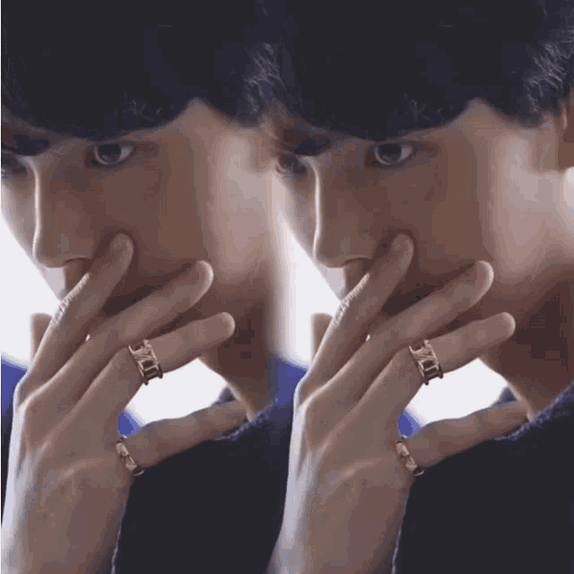 a close up of a person 's face with a ring on their finger that says dior