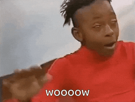 a young boy in a red shirt is making a funny face and says wooow .