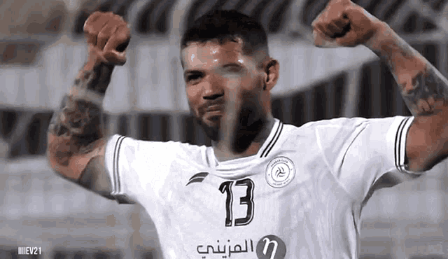 a soccer player in a white jersey with the number 13 on it