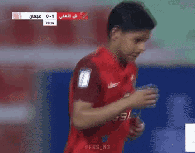 a soccer player in a red jersey with the number 91 on the back