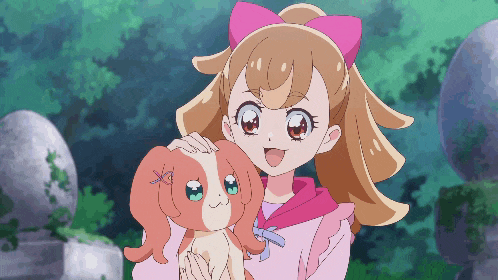 a girl with a pink bow on her head is holding a dog