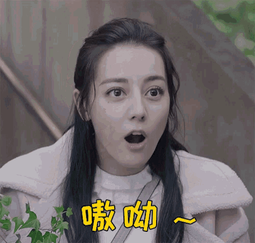a woman with a surprised look on her face is wearing a white shirt and a pink coat .