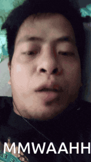 a close up of a man 's face with the words mmwaahh written on the bottom